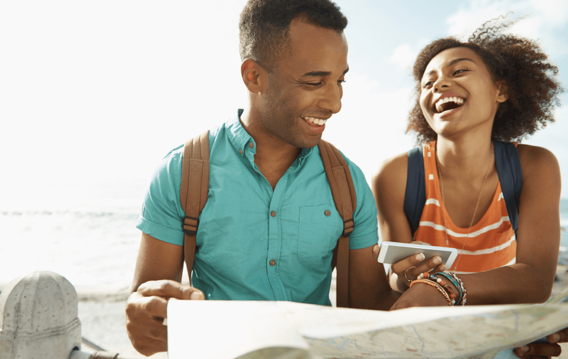 Young couple sitting together looking at map