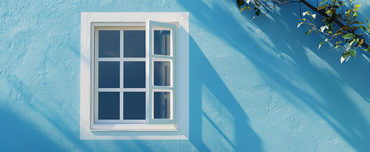 Opened window on a blue building