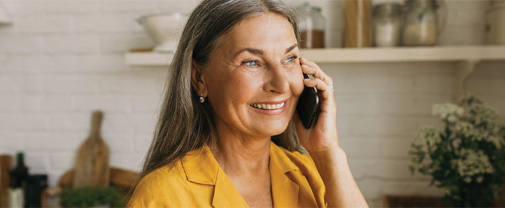 Woman smiling while talking on mobile phone