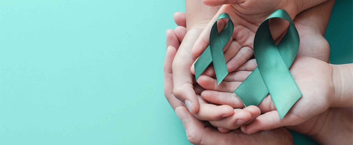 Hands holding teal ribbon for Cervical Cancer Awareness Month