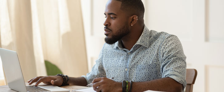 Man scrolling on laptop