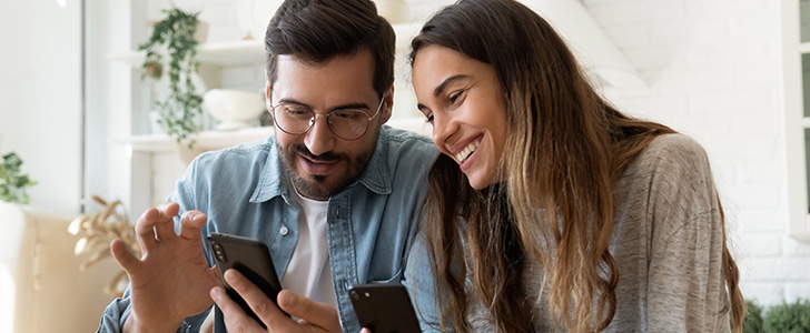 Man and woman using smartphones