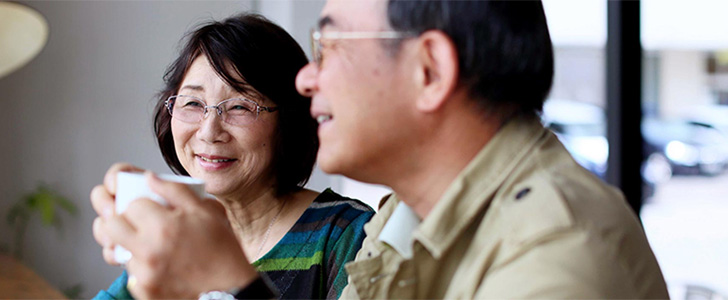 Older couple smiling together while drinking tea