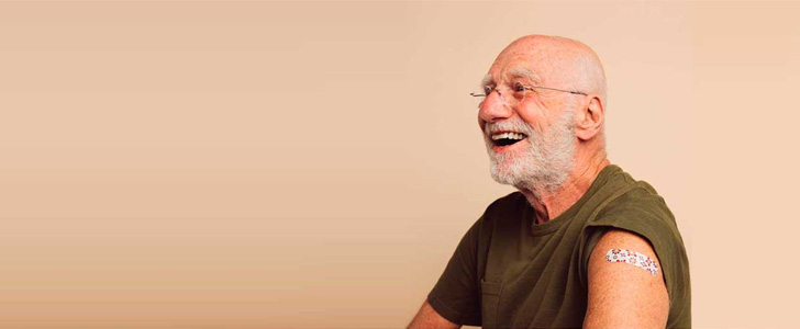 Senior man smiling after receiving flu shot