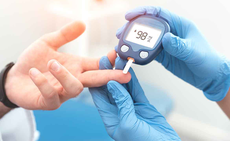 Doctor taking blood sugar level using glucometer